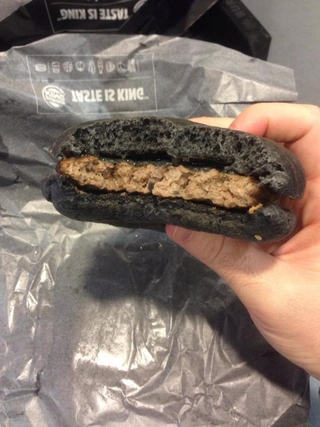 Illustration for article titled Burger King's all-black burger looks absolutely disgusting in real life